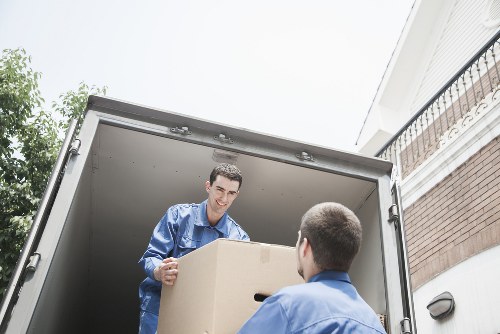 Volunteers loading donated furniture into a charity van for reuse