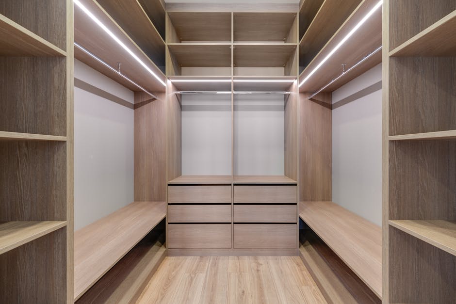 A row of grey metal parcel lockers with numbered compartments, seen inside a building, with a tiled flooring in the foreground. The lockers vary in size, with some featuring digital keypads and card r